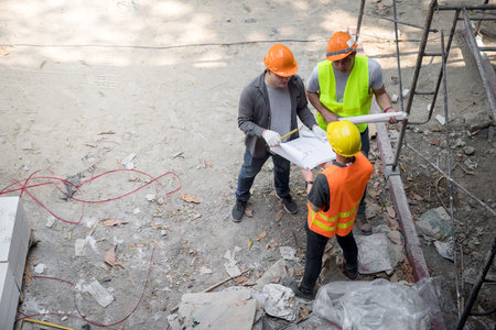 Confident team of architect working together in building construction site. They discussing about new startup project. Architect discuss with engineer about project . Architectural concept.の写真素材