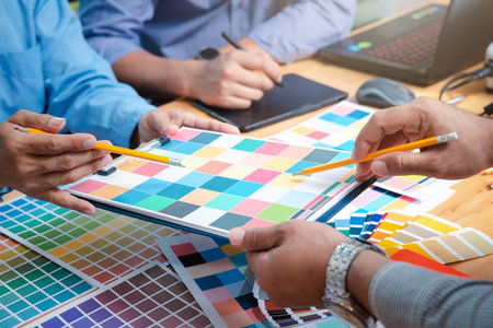 Interior designer chooses a color chart for home design. Graphic designers working on color chart at modern office.の写真素材