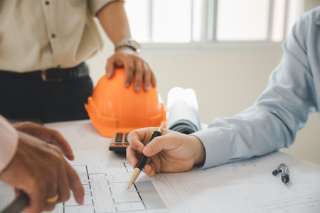 Confident team of architect working together in a office.Then discussing about new startup project on desk. Architect discuss with engineer about project in office, architectural concept.の写真素材
