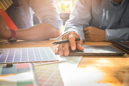 Interior designer chooses a color chart for home design. Graphic designers working on color chart at...