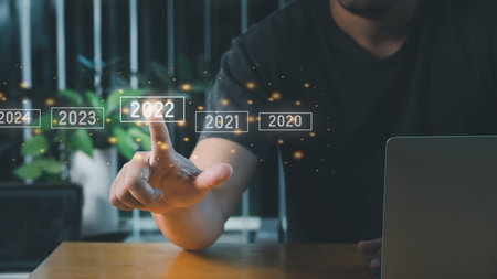 A man touching on virtual screen 2022. Business new year concept, welcome to year 2022 concept.の写真素材