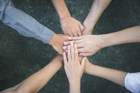 Top view of group of people team showing unity with putting their hands together in circle. Diversity hands join together for support and teamwork. Concept of teamwork.の写真素材