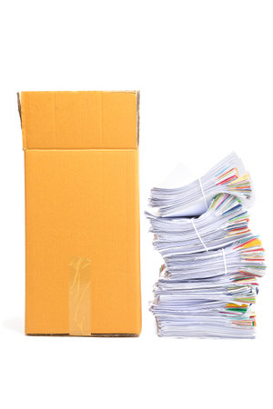 Stack of Documents and corrugated cardboard box isolated on white background.