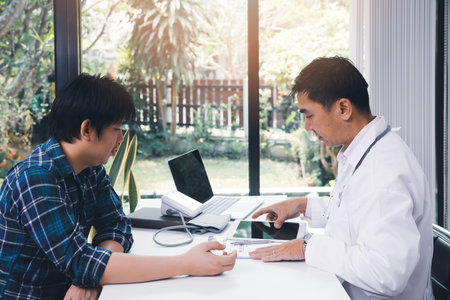 A doctor consulting and explain patient health check in office. Medicine and health care concept.の写真素材