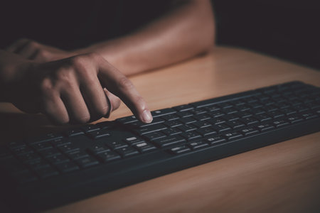 Closeup shot of man hand pressing enter key on computer keyboard.の写真素材