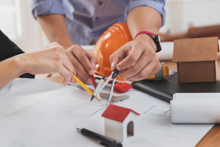 Group of two coworkers working with blueprint in office. co-working teamwork concept.の写真素材