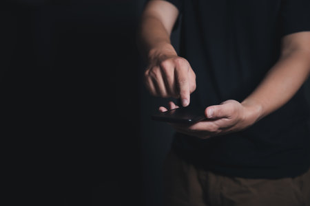 Close up man hand hold and pressing smartphone. Communication technology with copy space.