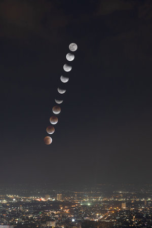 Total Lunar Eclipse and trails phase over Chiang Mai city, Thailand.の写真素材