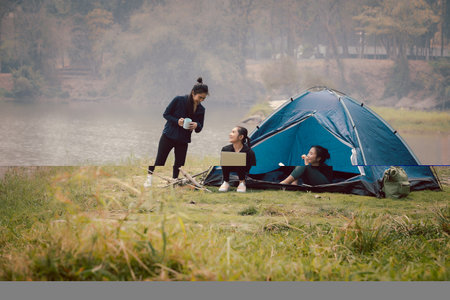 Group of Asian pretty woman camping by the tent. Outdoor activity, adventure travel, holiday vacation concept.の写真素材