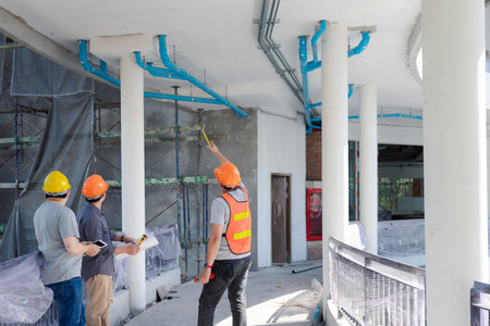 Engineer, foreman, Architect, contractor and worker discussing about project in building...