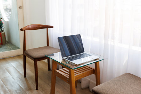 Minimal workplace with open laptop computer and notebook on desk. Mock up Copy Space Blank Screen...