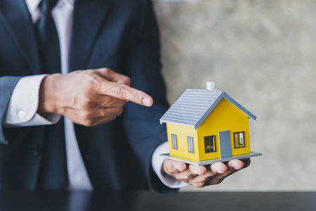 Real estate broker residential house rent listing contract. Your new house in hands. Offer of purchase house, rental of Real Estate. Holding house representing home ownership and the Real Estate.の写真素材