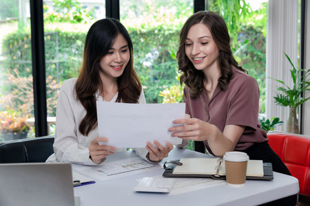 Businesswoman Consulting meeting working and brainstorming new business project finance investment concept. Business team analyzing income charts and graphs.の写真素材