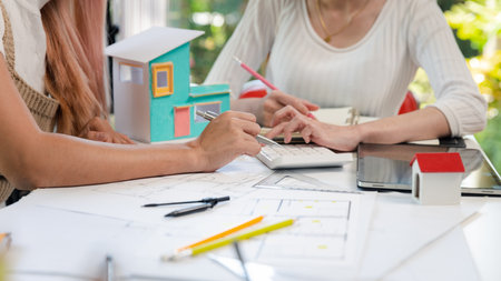 Confident team of female architect working together in a office. They discussing about new startup...