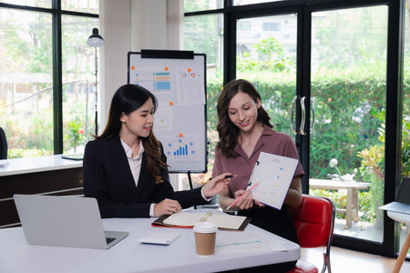 Businesswoman Consulting meeting working and brainstorming new business project finance investment concept. Business team analyzing income charts and graphs.の写真素材