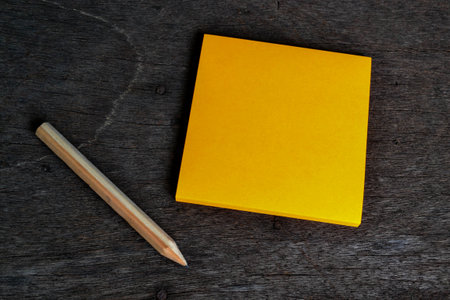 Orange post note and wooden pencil is ready to use
