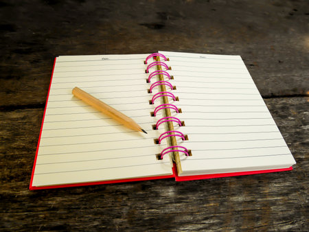 Note book with pencil on wooden tableの写真素材