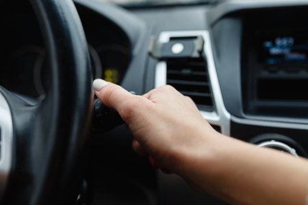 Hand holding switch light of car.の写真素材