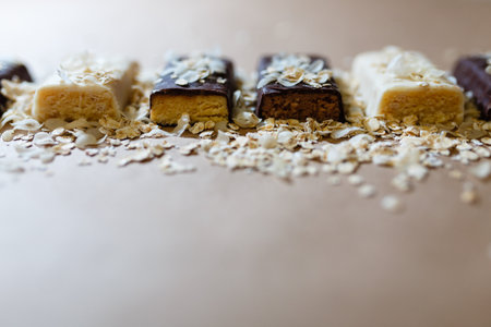 Snack chocolate protein bars with different flavors in the context of sprinkle rice flakes on baking paper,の写真素材
