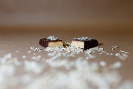 Closeup protein bar in the cut sprinkled with rice flakes on the baking paperの写真素材