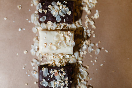 Snack chocolate protein bars with different flavors in the context of sprinkle rice flakes on baking...