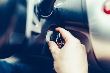 The driver of the man gets a car with a key. The hand inserts the key into the ignition and starts...