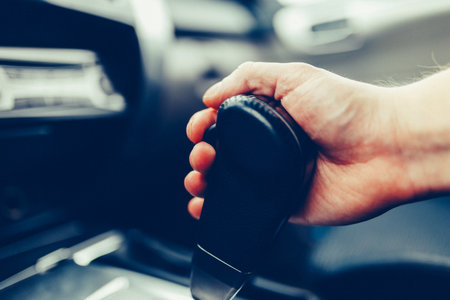 The man hand switches the automatic transmission's close-up.の写真素材