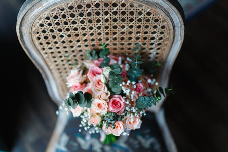 Stylish bouquet of flowers on an old chair. Wedding bouquet of fresh flowers on a chair, close-up, loft style.の写真素材