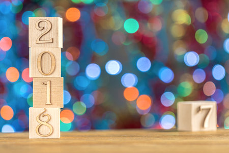 2018 in the foreground, displaces 2017. Christmas card. On bright bokeh background. Copy space for...
