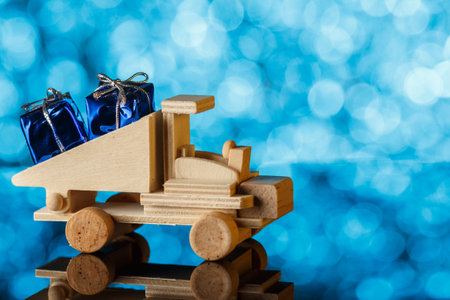 Delivery of gifts. Toy truck drives a little gift. Holiday card. A place for congratulations.の写真素材