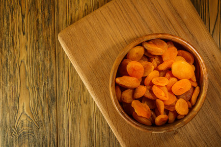 Dried apricots, place for lettering. wooden table, rustic style. Sun-dried fruit.の写真素材