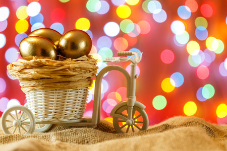 Easter card. Golden eggs in a Bicycle cart. Egg. happy Easter.の写真素材