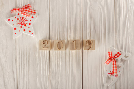 Christmas card, wooden cubes on a wooden background. Home cozy design. Happy new year 2019.の写真素材