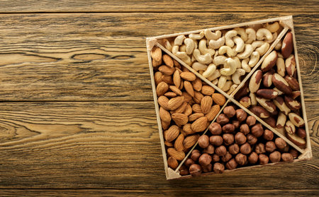 Assorted nuts. Set of nuts top view. Wooden table top. Texture background. Place for advertising text.の写真素材