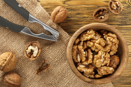 Walnut, shell cleaning process. Natural product on a wooden table. Rustic style.の写真素材