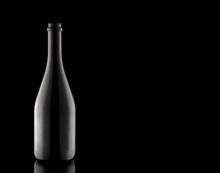 A bottle of champagne on a black background. A container of wine. Carbonated beverage. Festive alcohol.の写真素材