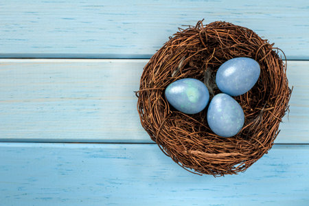 Happy Easter, the religious holiday of Holy Easter. Wooden background, rustic style. Egg hunt.の写真素材