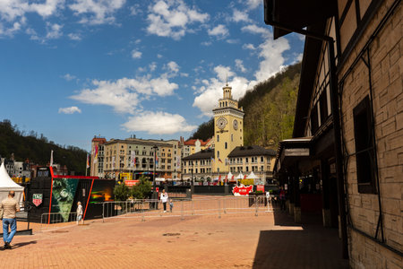 Rosa Khutor. The clock tower on the central square. Town hall. People walk around the square. Russia Sochi Rosa Khutor.のeditorial素材