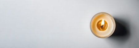 top view of burning candle on gray background, panoramic shotの素材