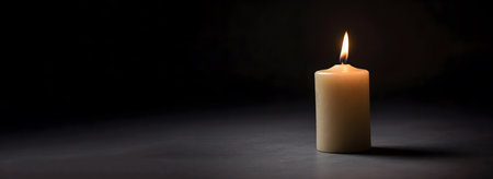 Burning candle on a dark background. copy space. Banner.の素材