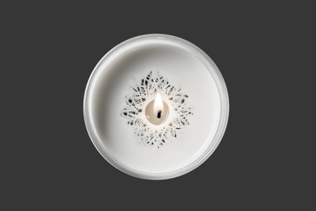 White candle in glass holder isolated on gray background. top view.の素材