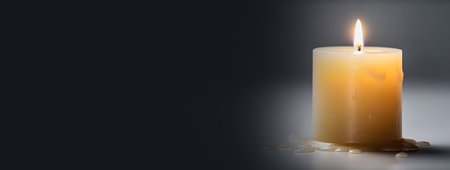Burning candle on a dark background with space for your text.の素材