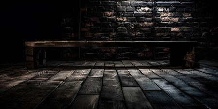 Wooden bench in front of a brick wall in a dark roomの素材