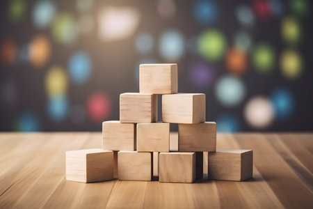 Wooden blocks stacked on top of each other on wooden table and bokeh background. Business growth conceptの素材