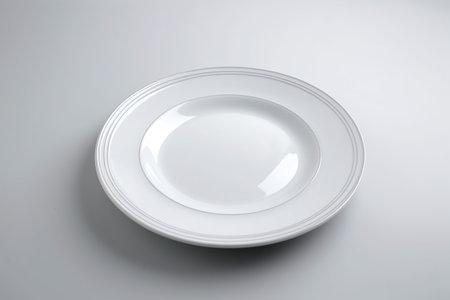 Empty white plate on a white background, top view, copy spaceの素材