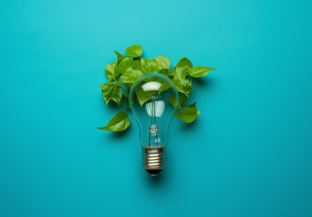 Idea concept with light bulb and green leaves on blue background.の素材