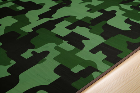 Camouflage pattern on wooden table, closeup. Camouflage backgroundの素材