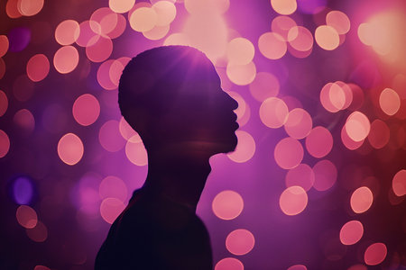 Silhouette of a man in front of a colored bokeh backgroundの素材