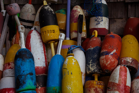 Old colorful lobster buoys in New England coast