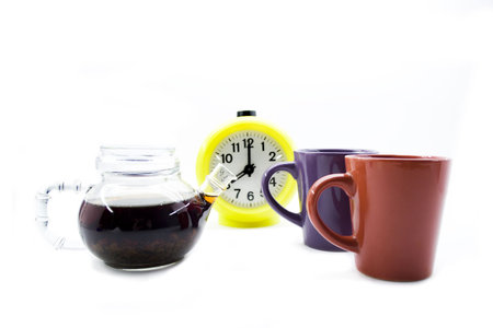 Teapot, cups and hours isolated on a white background